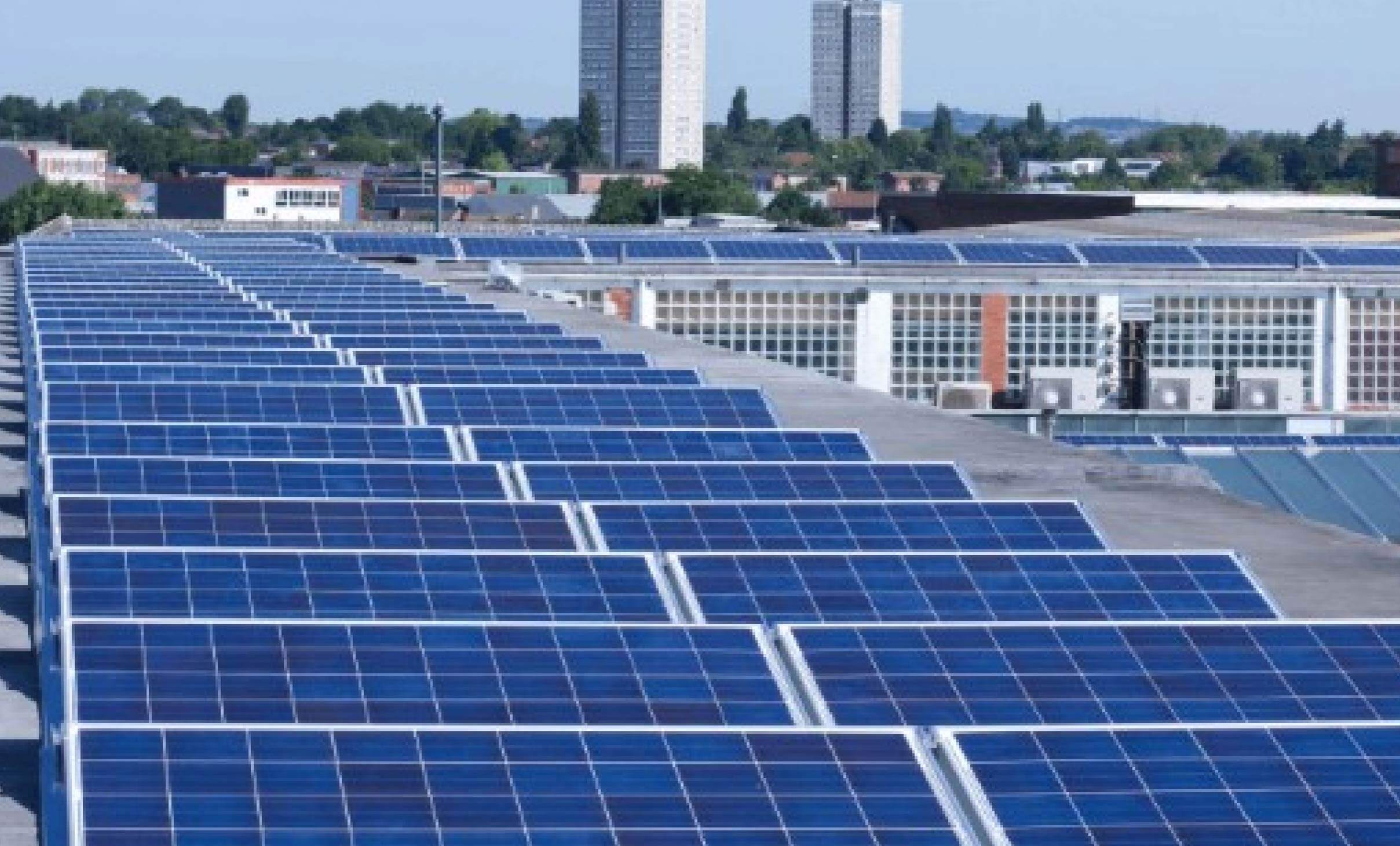Students in front of a solar-equipped school building